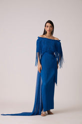 Model wearing a pleated royal blue dress with a fringe bodice.